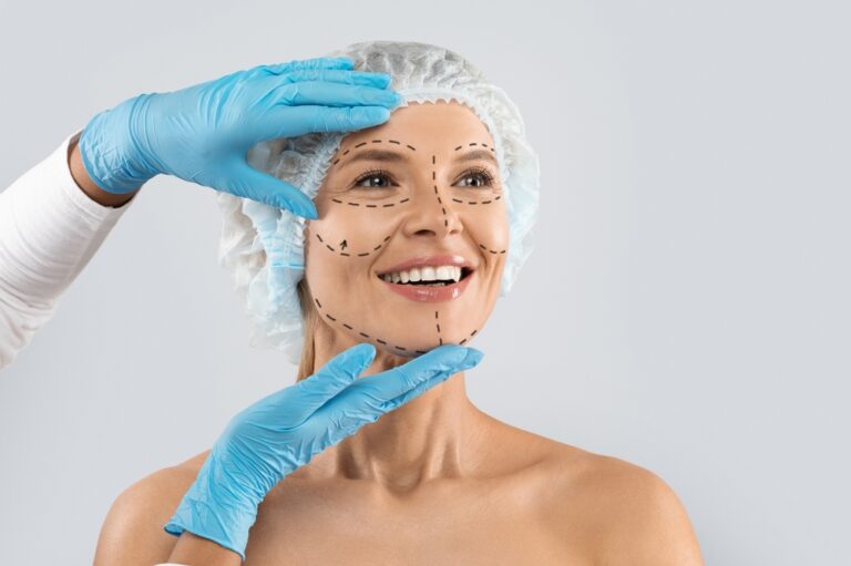 Cheerful middle-aged woman with pre-surgery face marks wearing medical hat, smiling as surgeon in blue gloves touches her skin before cosmetic procedure. Cheerful middle-aged woman with pre-surgery face marks wearing medical hat, smiling as surgeon in blue gloves touches her skin before cosmetic procedure.